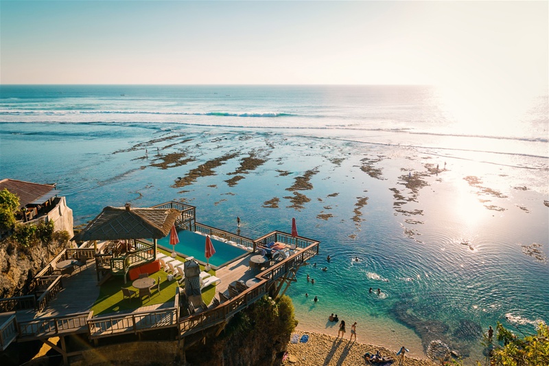 Evening view of the beach club swimming pool and the sea in Uluwatu, Bali island